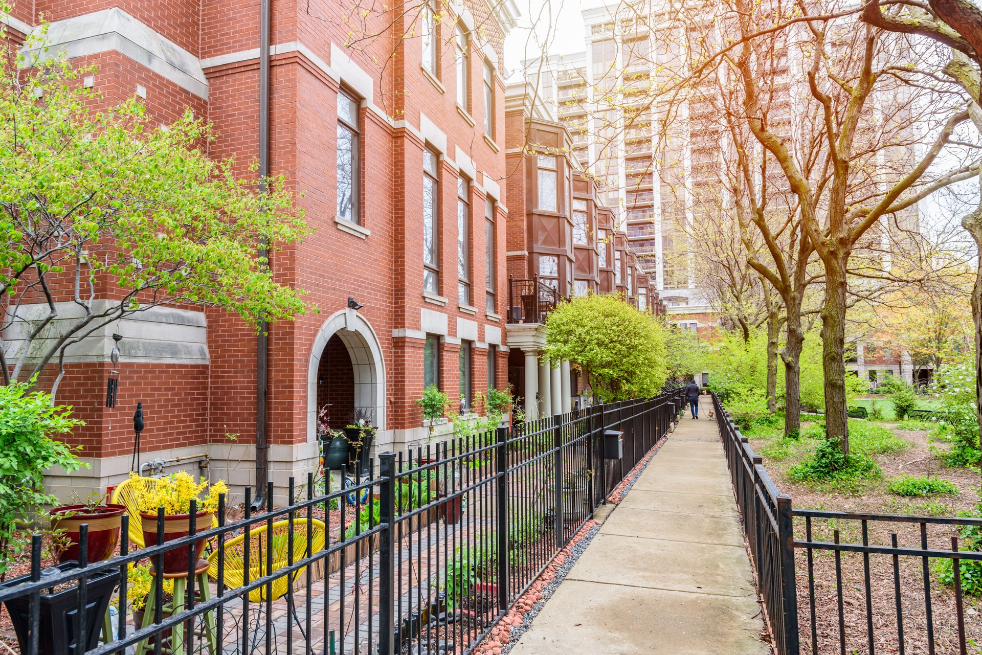 Row of modern town houses along a paved footpath